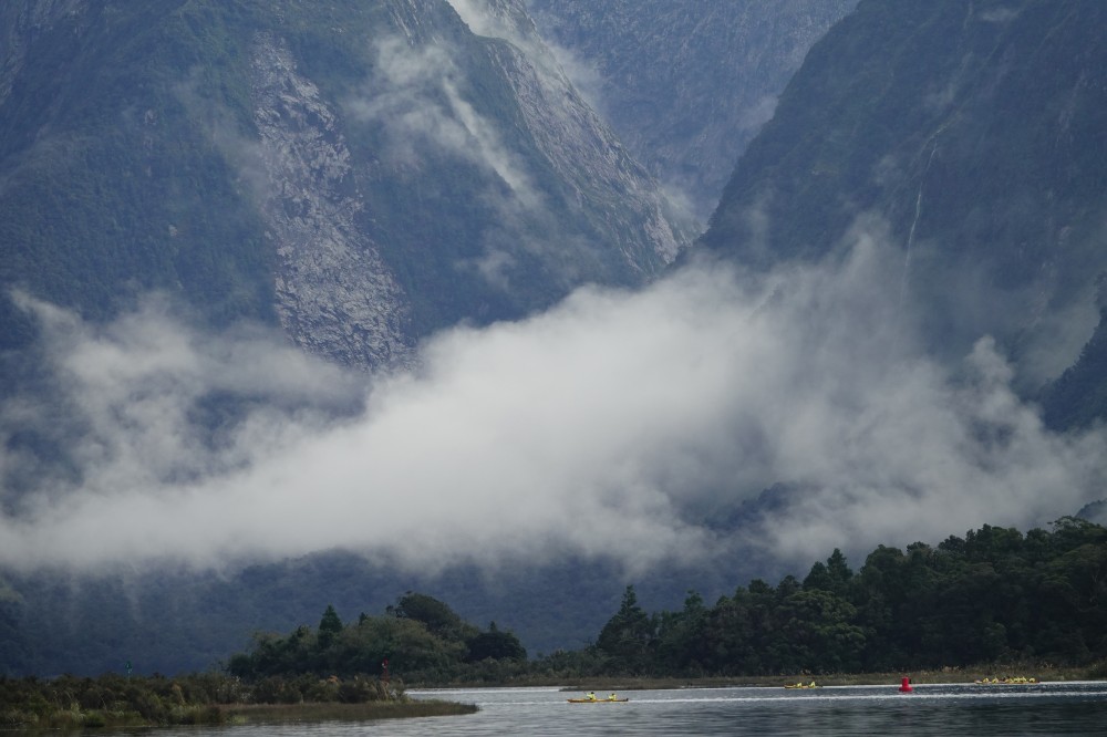 a large body of water with a mountain in the background